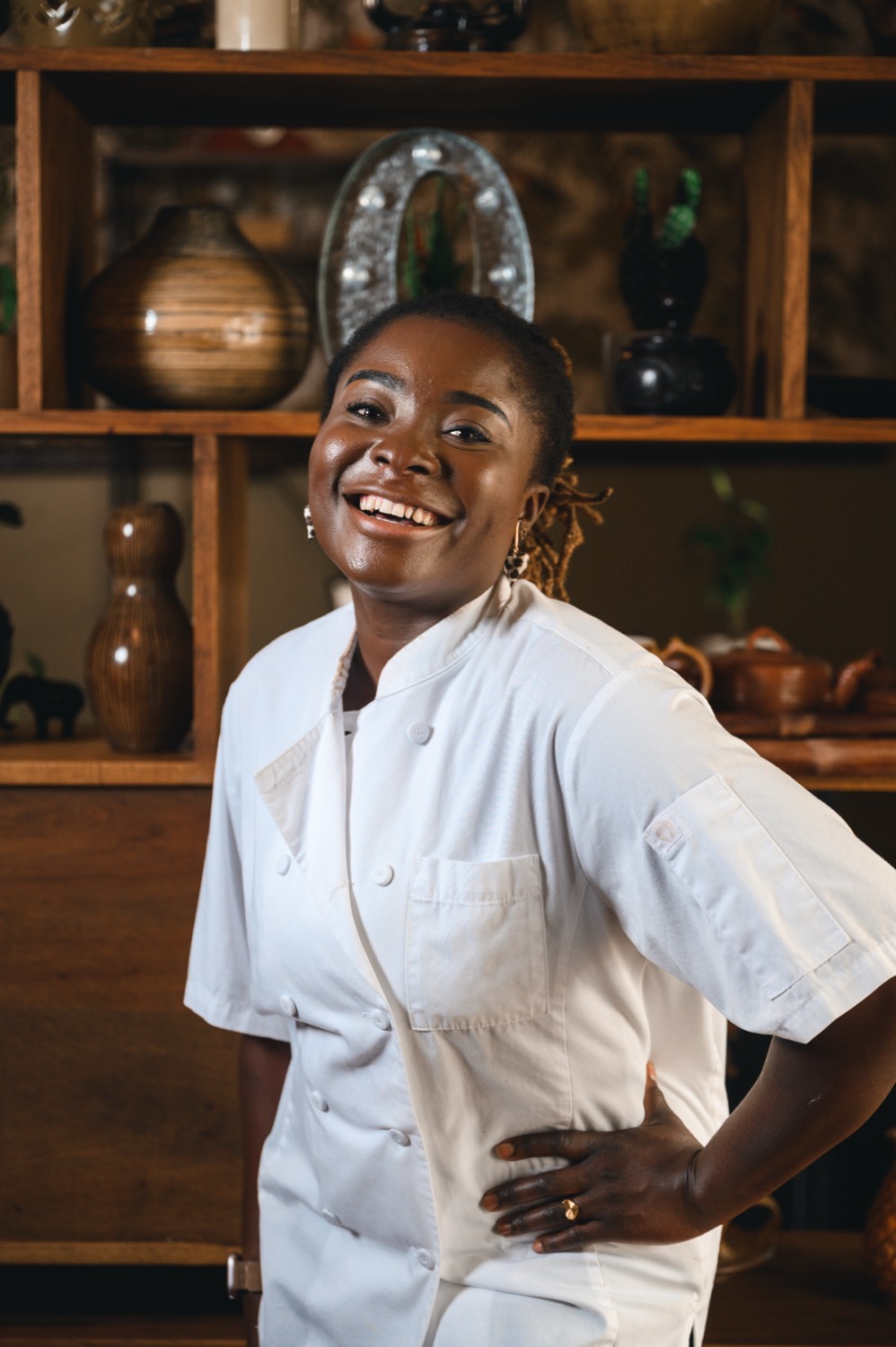 The chef-owner of Ahinke's smiling warmly in chef whites.