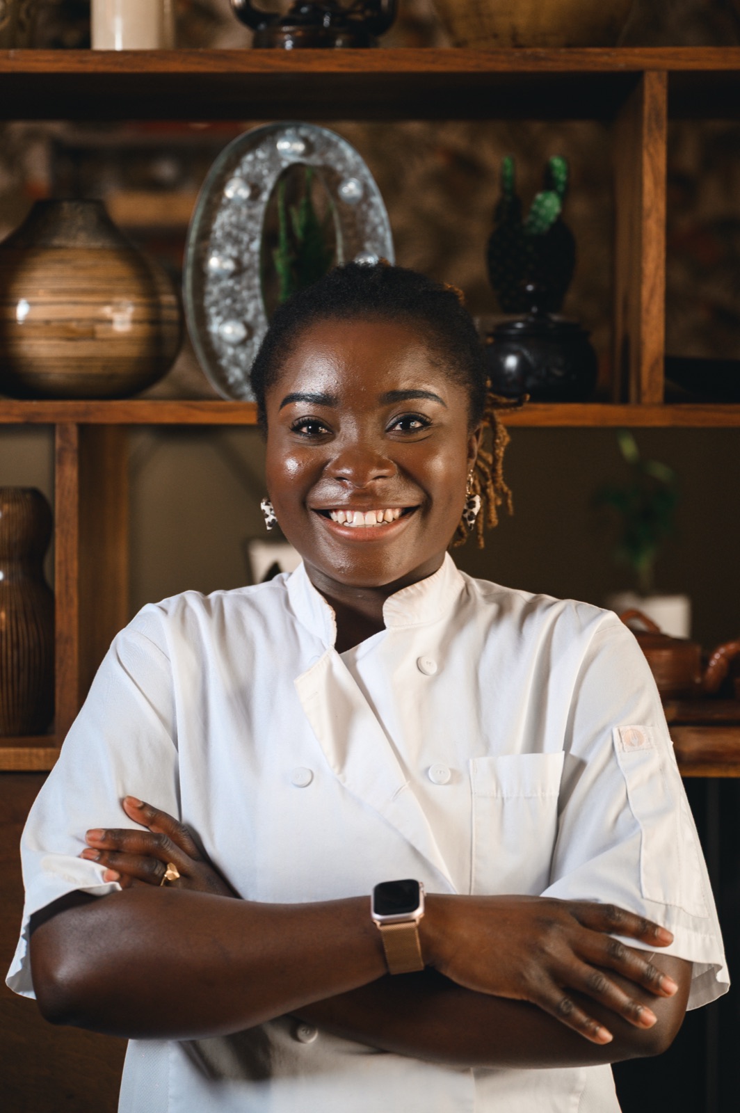 The chef-owner of Ahinke's smiling in chef whites, arms crossed.